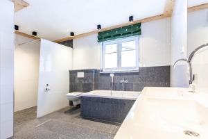 a bathroom with a tub and a toilet and a window at Casa de Wisa in Gaschurn +54 photos