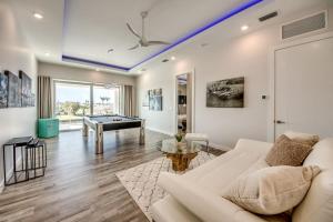a living room with a couch and a pool table at Masterpiece by CoralVilla, high end, luxurious in Shell Point Village