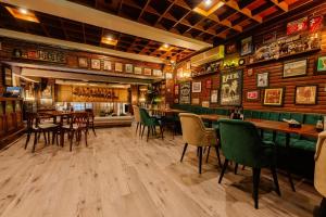 a restaurant with wooden walls and tables and chairs at Hotel Sport B90 in Buzău