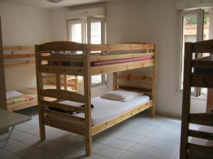 a room with three bunk beds in a room at La Petite Auberge de Saint-Sernin in Toulouse