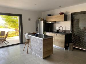 a kitchen with a counter and a refrigerator in it at Studio Mimosa in Crest