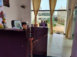 a lobby with a cash register and a large window at Ashirwad Hotel in Rīngas +41 photos
