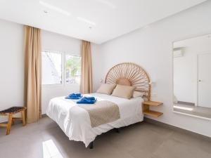 a bedroom with a large bed with blue towels on it at Amor a mar octopus in Puerto del Carmen