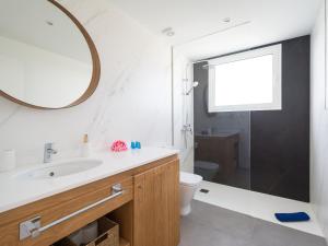 a bathroom with a sink and a toilet and a mirror at Amor a mar octopus in Puerto del Carmen +29 photos