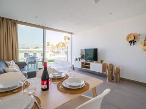 a living room with a dining table and a television at Amor a mar octopus in Puerto del Carmen