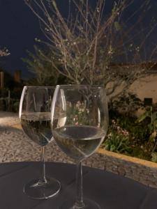 two glasses of white wine sitting on a table at Casa Jasmim in Sintra