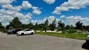 a white car parked in a parking lot at Ні пуху, ні пера! in Reshetylivka