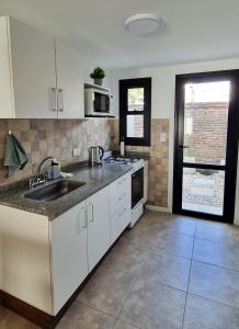 a kitchen with a sink and a counter top at NidoAparte III Lujan Centro-4 Pax-Duplex in Luján