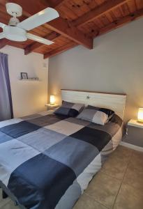 a bedroom with a large bed with a ceiling fan at NidoAparte III Lujan Centro-4 Pax-Duplex in Luján