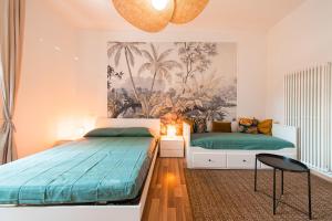 a bedroom with two beds and a painting on the wall at Becky in Bologna