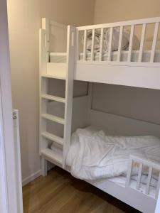 a white bunk bed in a small room at Appartement Admare Middelkerke in Middelkerke
