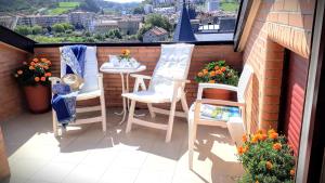 balkon z krzesłami i stołem z widokiem w obiekcie alaia apartamento w mieście Zarautz