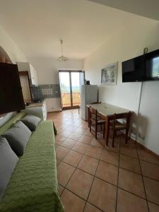 a living room with a couch and a table at Welcoming house in Vibo Valentia with shared pool in Vibo Valentia