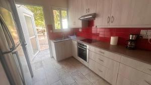 a kitchen with a sink and a stove top oven at Seafront Escape in Latchi in Polis Chrysochous