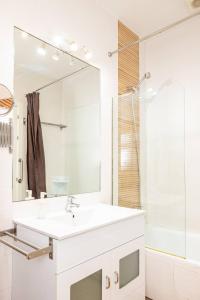 a white bathroom with a sink and a shower at Modern and spacious-2Bedrooms 1Bathroom-Malasaña in Madrid