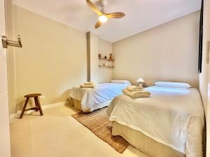 a bedroom with two beds and a ceiling fan at Paradise Ocean and Volcano View in Playa Paraiso