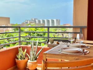 a table with plates and glasses on a balcony at Paradise Ocean and Volcano View in Playa Paraiso +35 photos