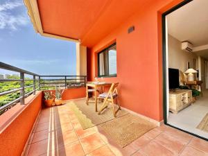 a balcony with orange walls and a table and chair at Paradise Ocean and Volcano View in Playa Paraiso