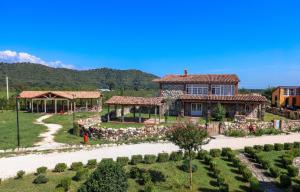 a large house with a garden in front of it at Anapea Village in Tkhilistskaro