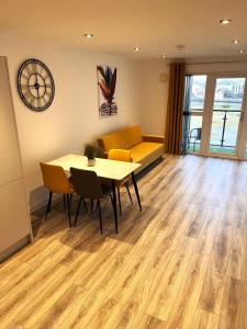 a living room with a table and a couch at Belfast View Apartment in Belfast