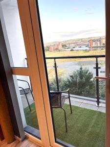 a view of a balcony with a chair and a window at Belfast View Apartment in Belfast