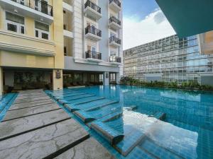 a swimming pool in front of a building at CB Suite Homes in Mandurriao