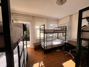 a room with three bunk beds and a window at Göreme Hostel in Goreme