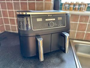 a microwave oven sitting on top of a kitchen counter at Top Floor Retreat Portmor- Sea, Beach & Balcony in Slievebane