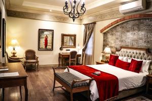 a bedroom with a large bed with red pillows at Three Rivers Lodge and Villas in Vereeniging