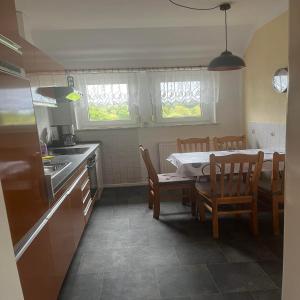 a kitchen and dining room with a table and chairs at Ferienwohnung Olendorp in Hermannsburg +10 photos