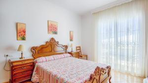 a bedroom with a bed and a dresser and a window at Castillo de la Hazalara Cómpeta by Ruralidays in Cómpeta +27 photos