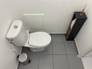 a white bathroom with a toilet and a sink at Aéroport CDG, Paris Disneyland, Eiffel Tower, JO 2024 in Montévrain +19 photos
