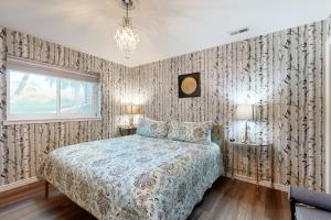 a bedroom with a bed and a window at Eagle River's Charmer in Edwards