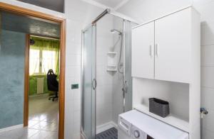 a white bathroom with a shower and a sink at Green House in Monopoli +15 photos