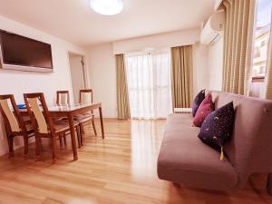 a living room with a couch and a table at Rosenheim Tokyo Shinjuku in Tokyo