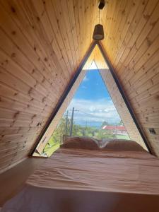a large window in a room with a bed at Demetra in Buknari