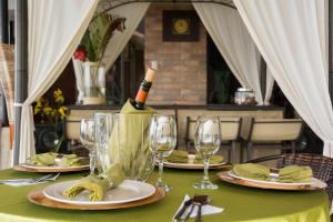 a table with glasses and a bottle of wine on it at Hosteria Florecer in Piñas
