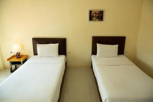 Postel nebo postele na pokoji v ubytování Sasi Nonthaburi Hotel