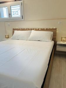 a bedroom with a large white bed with lights on it at Casa di campagna 'Sa Vinzedda' in Galtellì