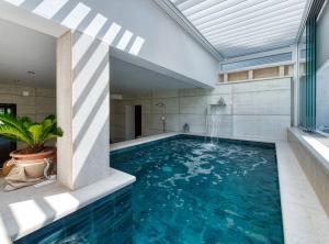 a swimming pool in the middle of a house at Luxury Private Spa Apartment with Heated Pool & Sauna and Sea View in Cavtat