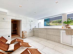 a large bathroom with a shower and a sink at Luxury Private Spa Apartment with Heated Pool & Sauna and Sea View in Cavtat