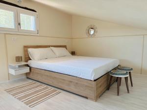 a bedroom with a large bed and a window at Casa di campagna 'Sa Vinzedda' in Galtellì
