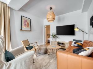 a living room with two couches and a flat screen tv at Luxury B.one Apartment in Cavtat