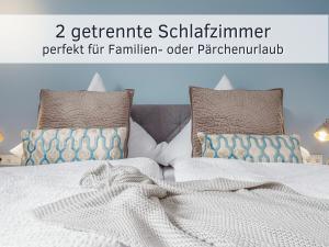 Katil atau katil-katil dalam bilik di Lotsendeck Fehmarn mit Terrasse & Garten, barrierearm +25 gambar