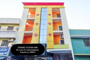 Un edificio alto con un cartel delante. en Grand Ocean inn, en Pondicherry