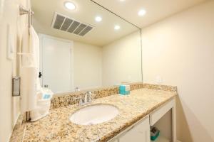 a bathroom with a sink and a large mirror at Tropical Retreat Coastal 1BR Getaway with Balcony 212 in South Padre Island +11 photos