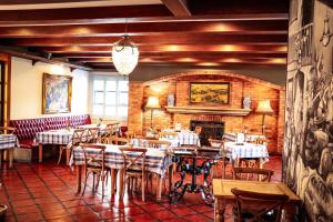 a restaurant with tables and chairs and a brick wall at Three Rivers Lodge and Villas in Vereeniging