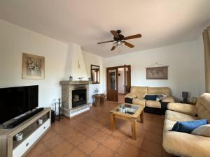 a living room with a couch and a tv at Casa Wenne - Private Pool with view in Sedella