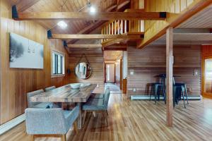 a dining room with a wooden table and chairs at Serenity by the lake in Eden