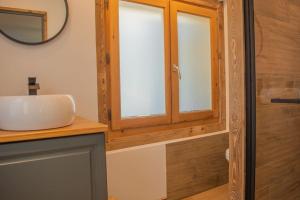 a bathroom with a sink and a mirror at Studio Miloé secteur TMB in Saint-Gervais-les-Bains